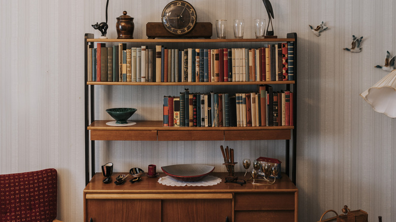 A vintage bookshelf with books and decor.