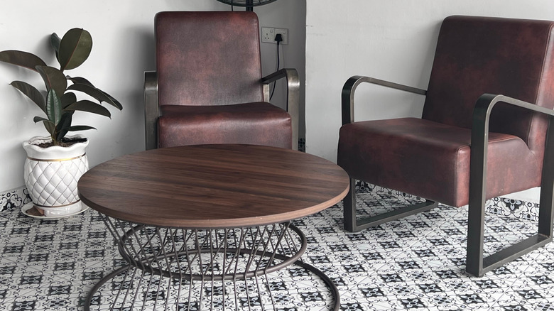 Two vintage mid-century leather arm chairs.