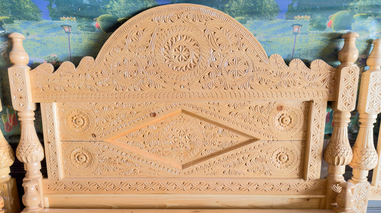 An ornate wooden headboard with carved details