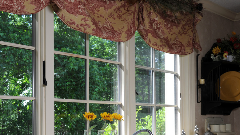 A modern kitchen with a country feel, valance in window.
