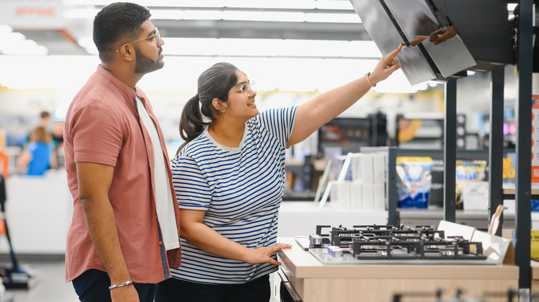 A couple shopping for appliances.