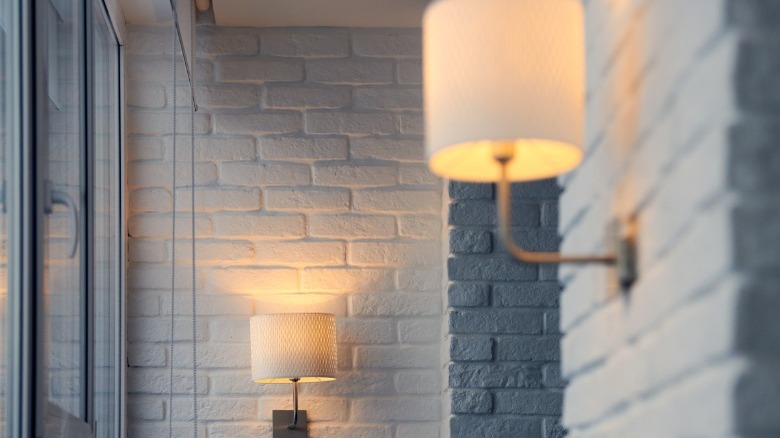 Wall sconces on brick wall 