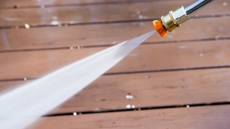 Power washer spraying at an angle