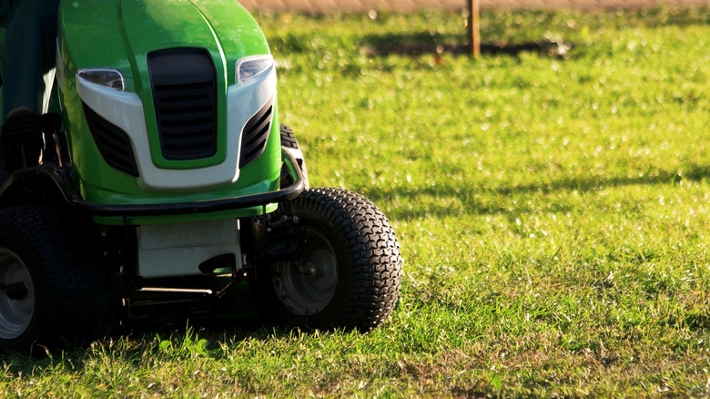 John Deere mower at work on a lawn
