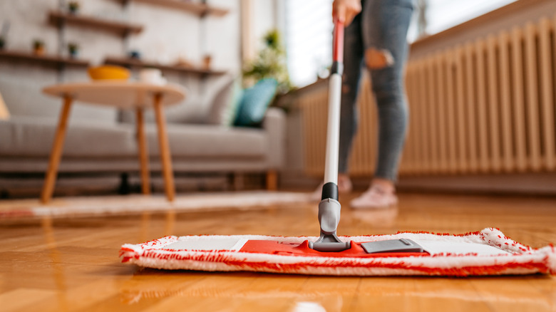 Woman mopping wooden floor
