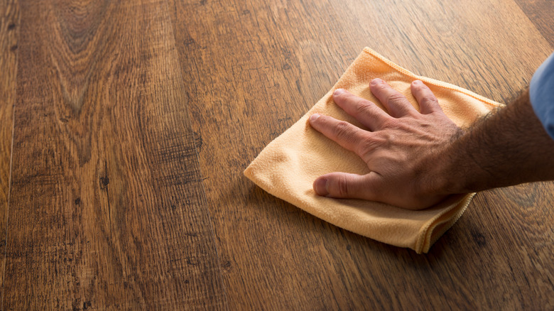 Man cleaning floor with cloth
