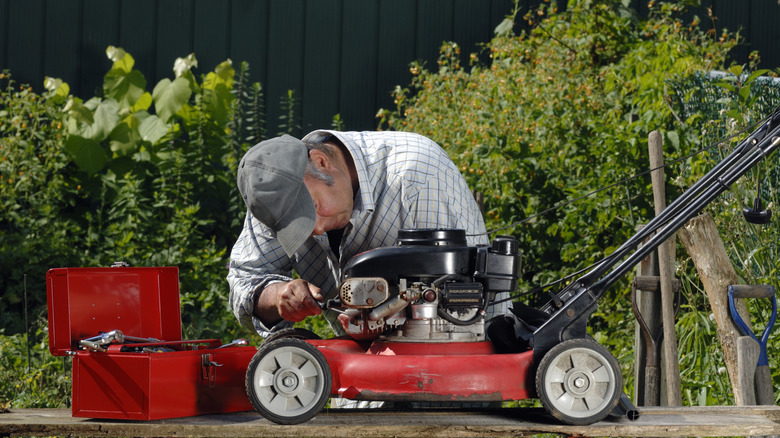 A professional working on a small lawn mower