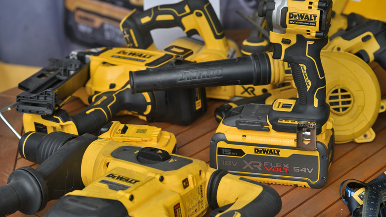 DeWalt tools and batteries on wooden table
