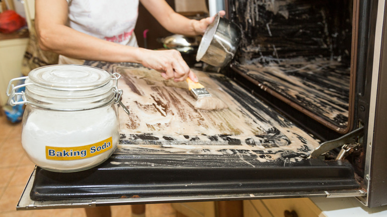 Cleaning a glass oven door with a thick paste of baking soda and water