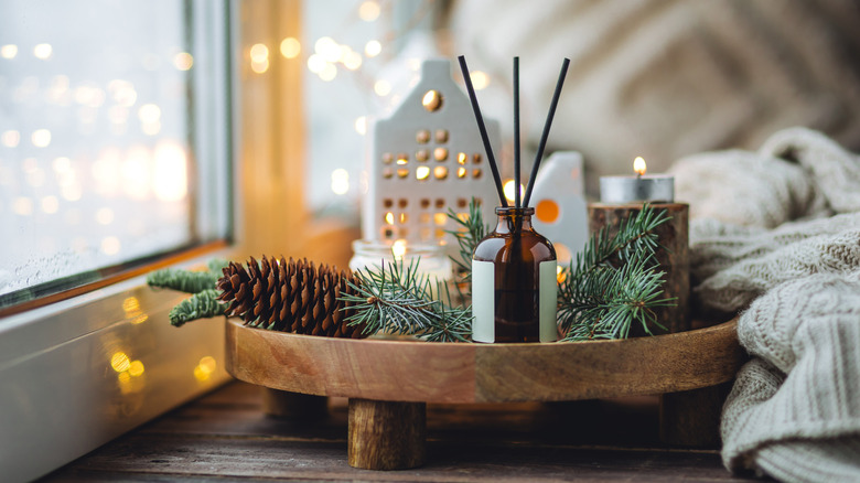 Natural decor on wooden tray featuring pine cones and pine branches