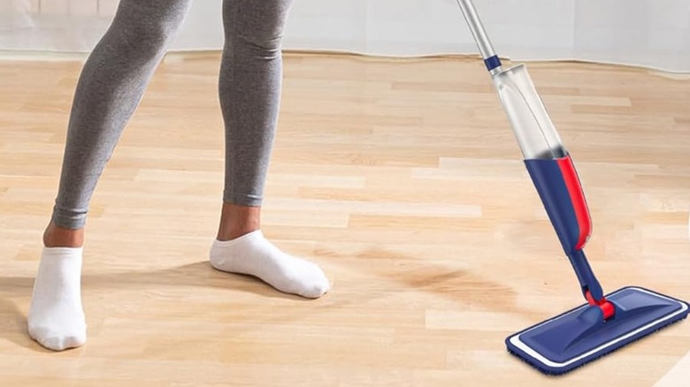 A woman cleaning a hard floor with a Mexerris spray mop