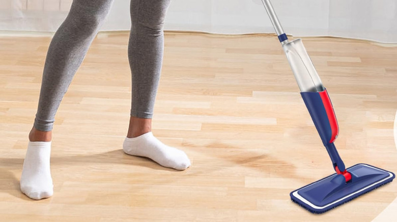 A woman cleaning a hard floor with a Mexerris spray mop
