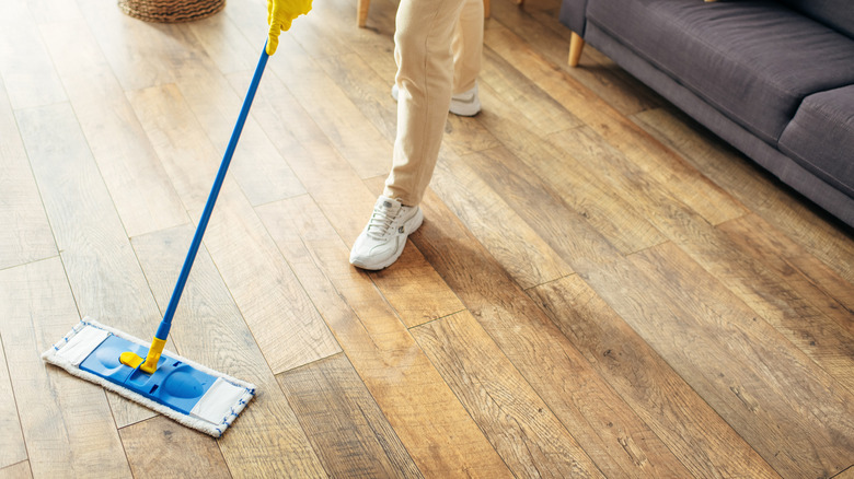 A person mopping wood floors