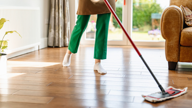 A person mopping a hardwood floor