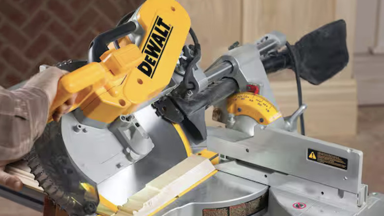Dewalt Miter Saw being adjusted to cut at an angle