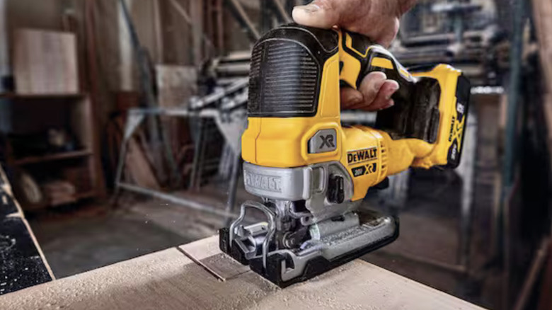 Dewalt jigsaw making cuts in a sheet of wood