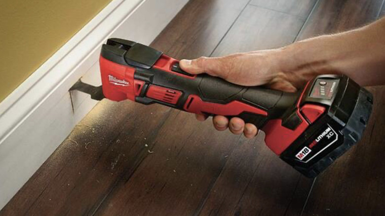 Milwaukee HACKZALL being used to cut baseboard