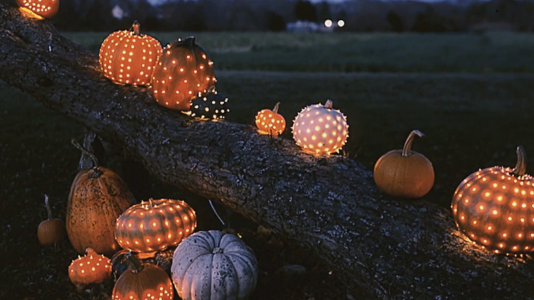 Pumpkins with holes for lights displayed putside