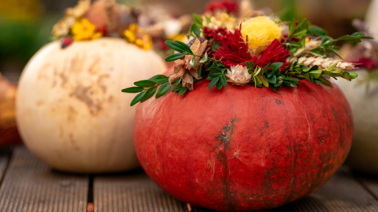 White and red pumpkins used as flower vases