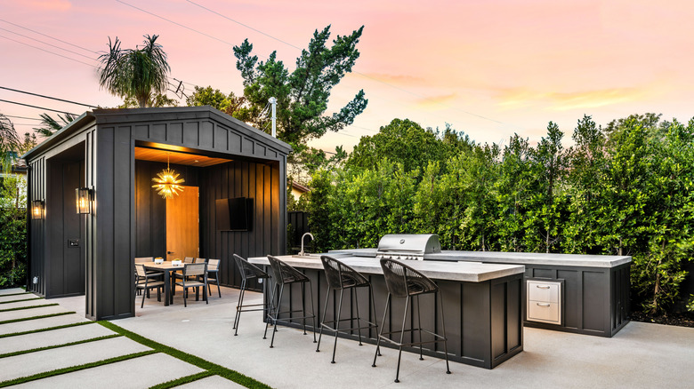 An outdoor kitchen on a patio at sunset