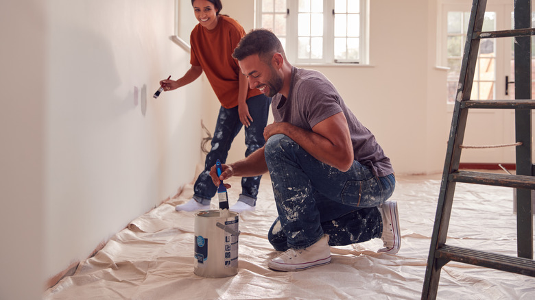 Couple painting home