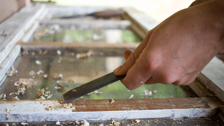 person stripping paint