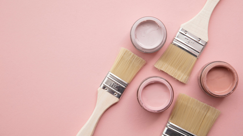 pink background paint pots brush