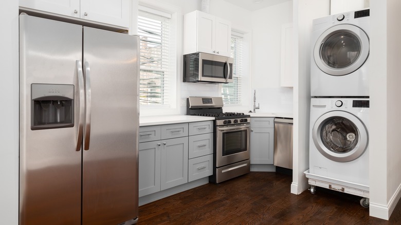 Stacked washer and dryer in nook in kitchen