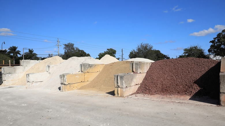 Bark, gravel, and rock landscaping supplies in a large commercial area available for bulk purchase.