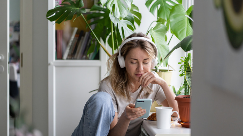 Woman relaxing at home with plants