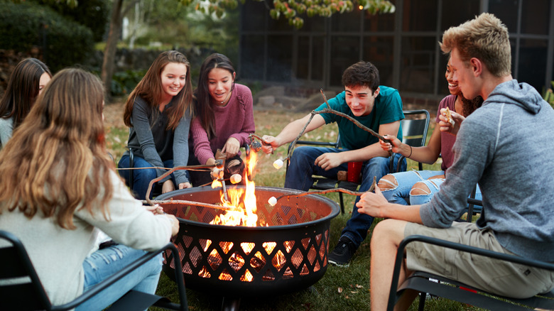 People sitting around fire pit