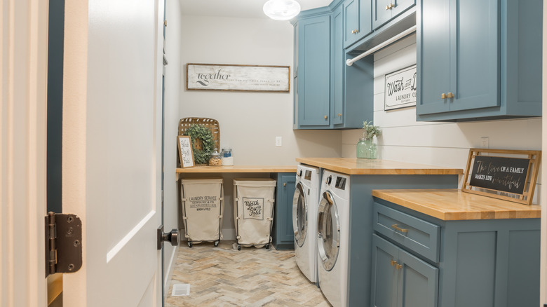 laundry room with blue cabinets