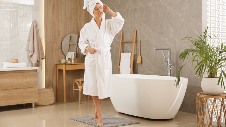 Woman wearing bathrobe in bathroom