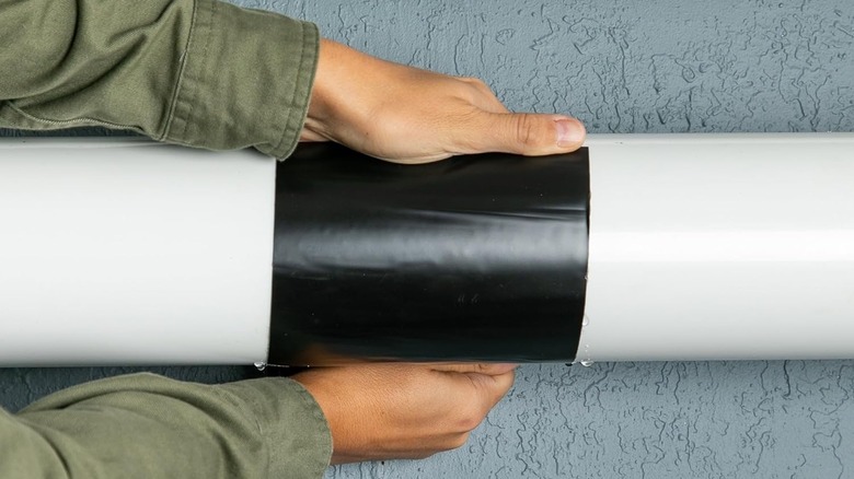Person applying Flex Tape to a leak in a pipe