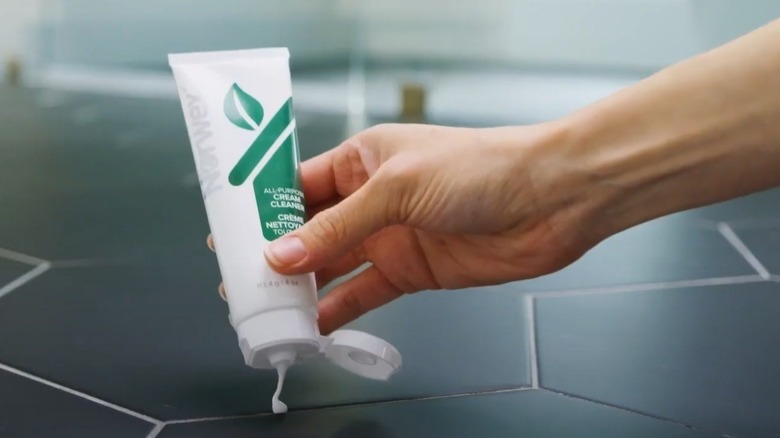 Person applying Norwex Cream Cleaner to a countertop