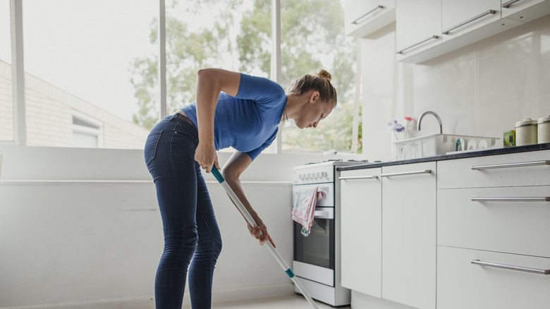 a woman cleaning her home with a KOJEO Electric Spin Mop