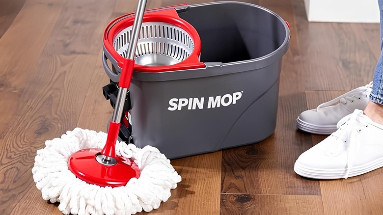 a woman mopping the floor with a SIMPLI-MAGIC 79349 Spin Mop
