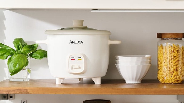 White Aroma rice cooker on a kitchen shelf