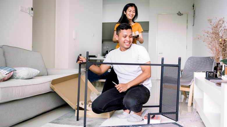 A couple putting a table together