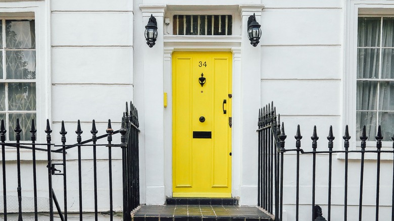 Yellow door with house number