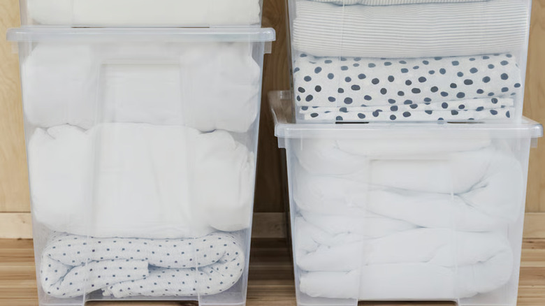 Clear IKEA SAMLA bins holding bedding