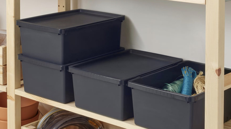 Black IKEA UPPSNOFSAD﻿﻿﻿ bins on a garage shelf