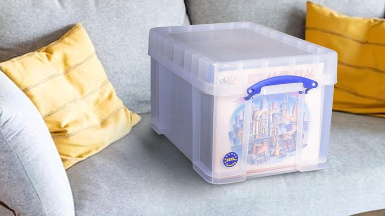 A clear vinyl record storage box sitting on a couch
