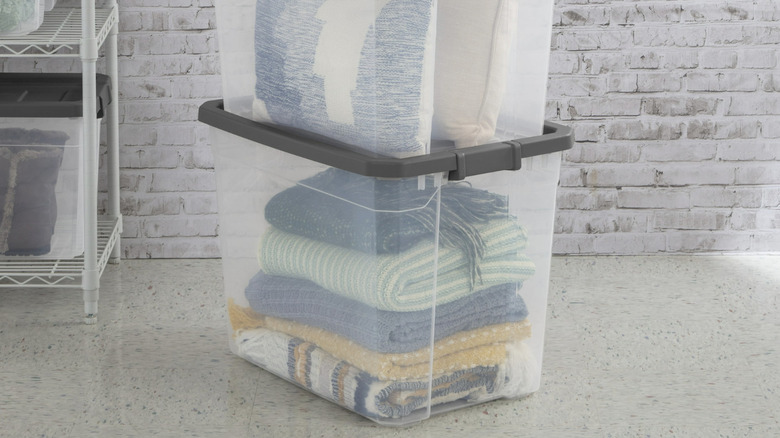 Sterilite Clear Storage Bins with gray lids holding blankets and pillows