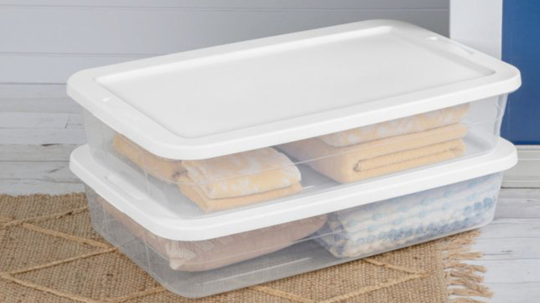 Target Brightroom's Under Bed Storage Boxes with white lids holding towels and pillows