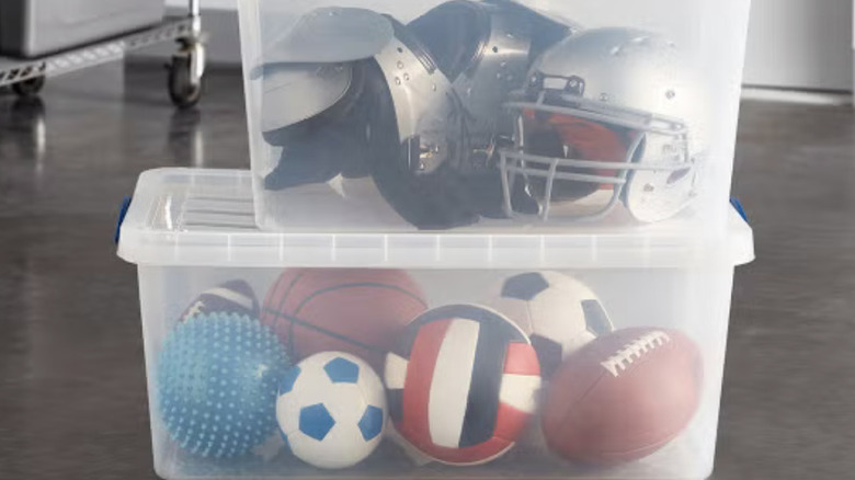 The Container Store clear stacking totes holding sports equipment