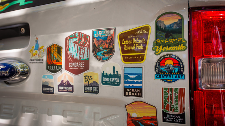 The back of a vehicle covered in state park stickers.