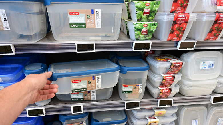 Plastic kitchenware on store shelves with stickers on them.