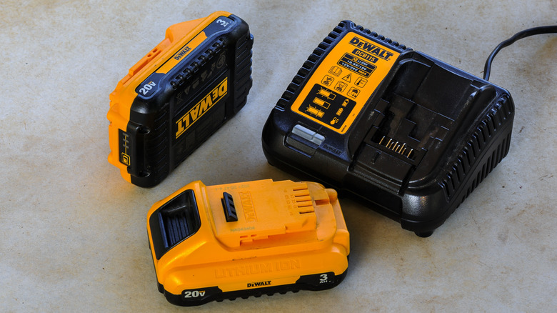 DeWalt batteries and chargers sitting on ground