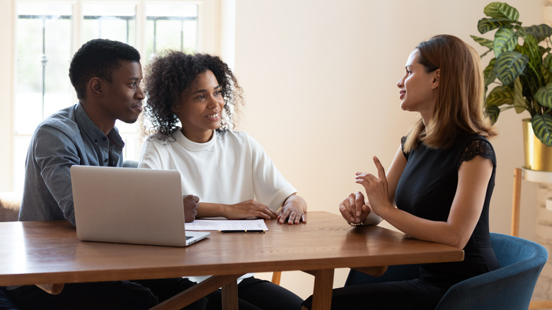 couple talking to realtor